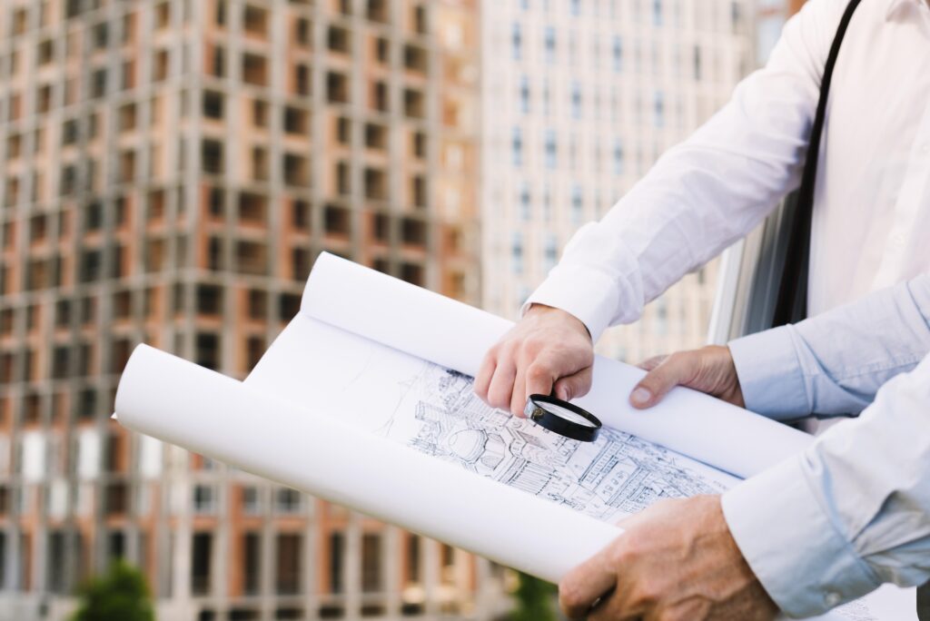 close-up-people-holding-building-sketch